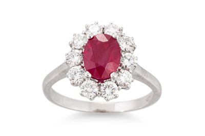 Lot 236 - A RUBY AND DIAMOND CLUSTER RING, the central...