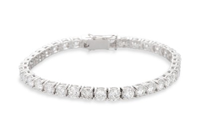 Lot 307 - A DIAMOND LINE BRACELET, the round brilliant...