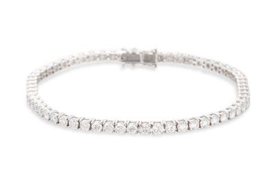 Lot 308 - A DIAMOND LINE BRACELET, the round brilliant...