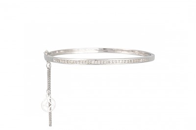 Lot 264 - A DIAMOND SET BANGLE, the princess cut...