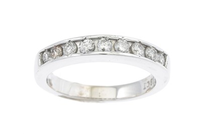 Lot 15 - A DIAMOND HALF ETERNITY RING, set with nine...