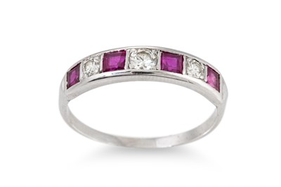 Lot 33 - A DIAMOND AND RUBY SEVEN STONE RING, mounted...