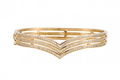 Lot 318 - A DIAMOND SET TRIPLE ROW HINGED GOLD BANGLE,...