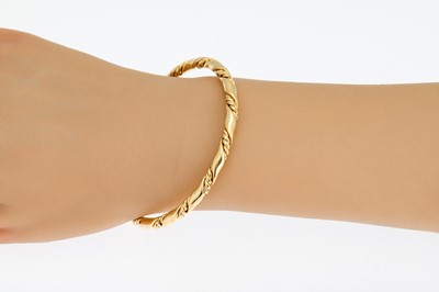 Lot 53 - AN 18CT GOLD BANGLE, twisted rope motif, 27.3...