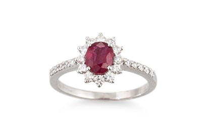 Lot 244 - A RUBY AND DIAMOND CLUSTER RING, the oval ruby...