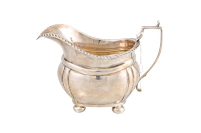 Lot 502 - A GEORGE V SILVER MILK JUG, of plain form on...