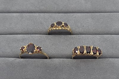 Lot 4 - THREE GARNET CLUSTER RINGS, all mounted in 9...