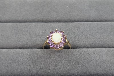 Lot 9 - AN OPAL AND AMETHYST CLUSTER RING, the oval...