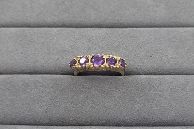 Lot 11 - A FIVE STONE AMETHYST RING, the graduated...