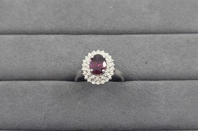 Lot 20 - A GARNET AND DIAMOND SET CLUSTER RING, the...