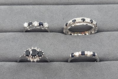 Lot 22 - FOUR SAPPHIRE AND STONESET RINGS, two set with...