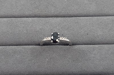 Lot 26 - A SAPPHIRE AND DIAMOND SET RING, the oval...