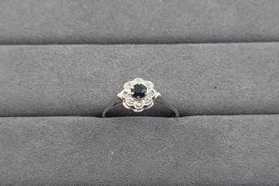 Lot 29 - A SAPPHIRE AND DIAMOND CLUSTER RING, the...