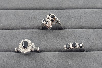 Lot 30 - THREE SAPPHIRE SET CLUSTER RINGS, two set with...
