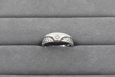 Lot 32 - A DIAMOND SET BAND RING, engraved detail to...