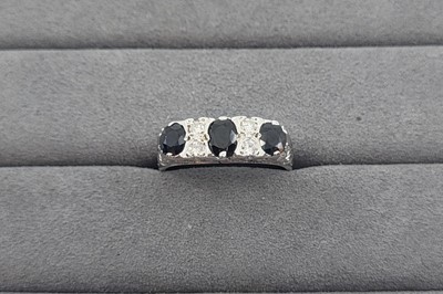 Lot 34 - A SAPPHIRE AND DIAMOND SET BAND RING, the...