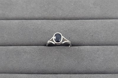 Lot 37 - A SAPPHIRE SET RING, the bezel set oval...