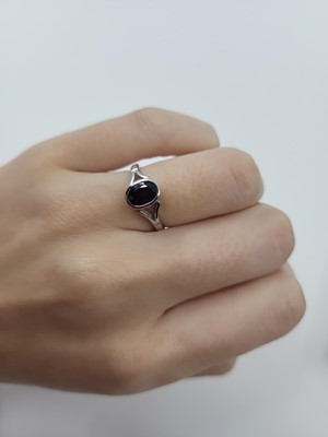 Lot 32 - A SAPPHIRE SET RING, the bezel set oval...