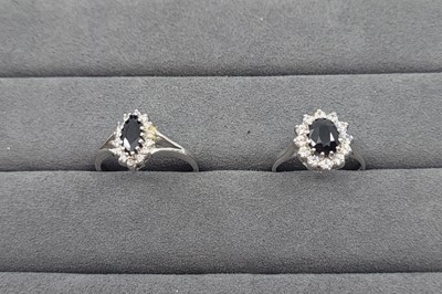 Lot 38 - TWO SAPPHIRE AND STONESET CLUSTER RINGS,...