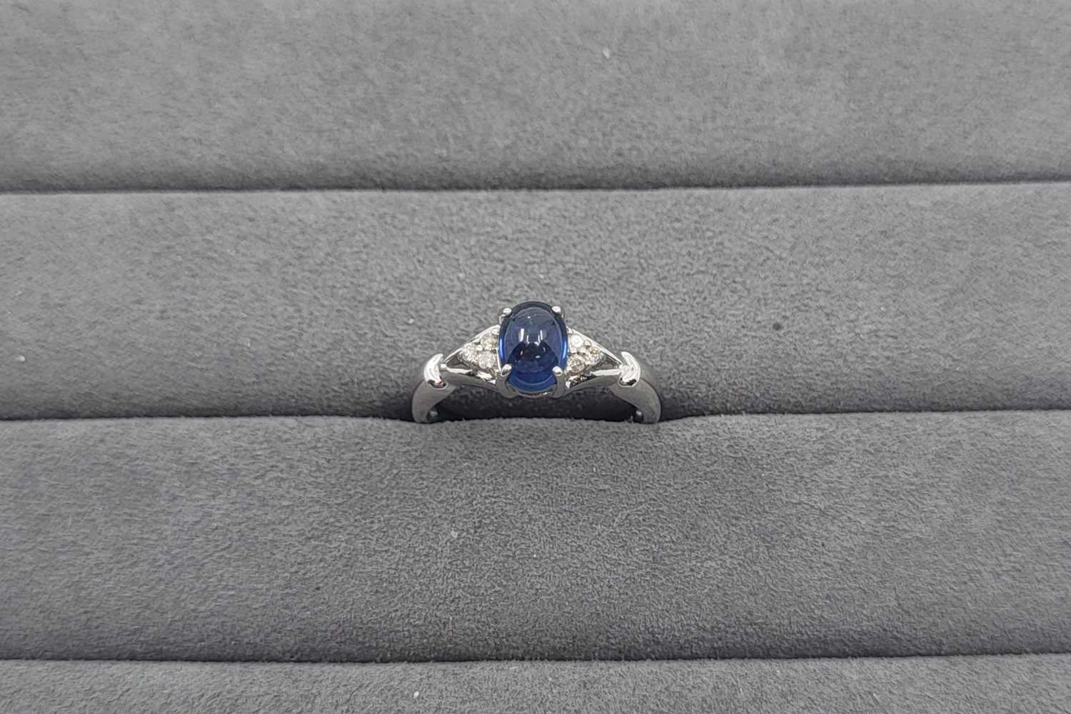 Lot 33 - A SAPPHIRE AND DIAMOND SET RING, the central...