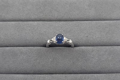 Lot 40 - A SAPPHIRE AND DIAMOND SET RING, the central...