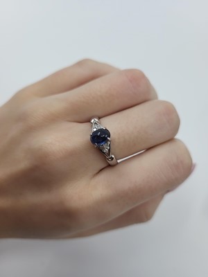 Lot 33 - A SAPPHIRE AND DIAMOND SET RING, the central...