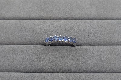 Lot 53 - A SEVEN STONE SET SAPPHIRE RING, mounted in 9...
