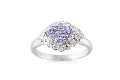 Lot 58 - A TANZANITE AND DIAMOND SET CLUSTER RING, the...