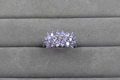 Lot 59 - A THREE ROWED TANZANITE SET CLUSTER RING, the...