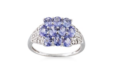 Lot 60 - A TANZANITE SET CLUSTER RING, the oval...
