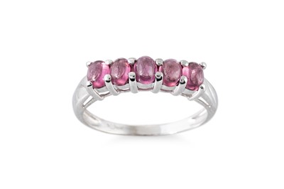Lot 64 - A GARNET FIVE STONE RING, the oval cabuchon...