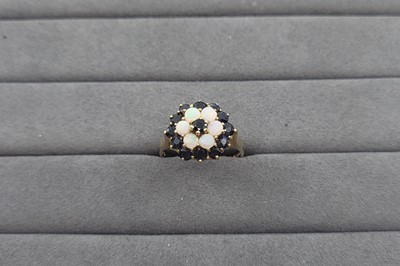 Lot 79 - A SAPPHIRE AND OPAL SET CLUSTER RING, the...