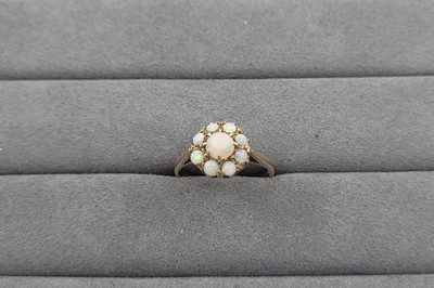 Lot 80 - AN OPAL CLUSTER RING, the round cabuchons...