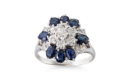 Lot 82 - A SAPPHIRE AND DIAMOND CLUSTER RING, the oval...