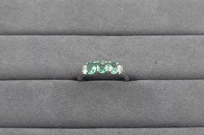 Lot 85 - AN EMERALD THREE STONE RING, the oval emeralds...