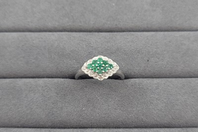 Lot 87 - AN EMERALD AND DIAMOND CLUSTER RING, the...