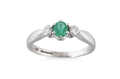 Lot 89 - AN EMERALD AND DIAMOND THREE STONE RING, the...