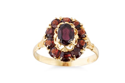 Lot 96 - A GARNET SET CLUSTER RING, the central oval...