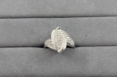 Lot 103 - A DIAMOND CLUSTER RING, the navette shaped...
