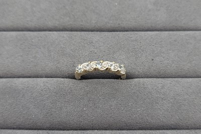 Lot 107 - AN AQUAMARINE AND DIAMOND SET BAND RING, the...