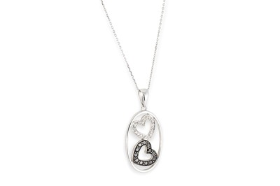 Lot 294 - A BLACK & WHITE DIAMOND LOVE HEART PENDANT, in...
