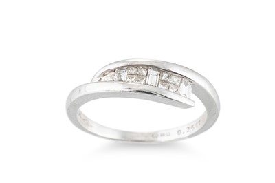Lot 302 - A CHANNEL SET DIAMOND CROSS OVER RING, mounted...