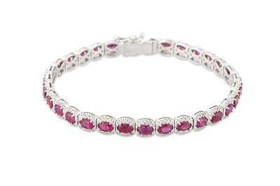 Lot 154 - A RUBY AND DIAMOND CLUSTER BRACELET, in 18ct...