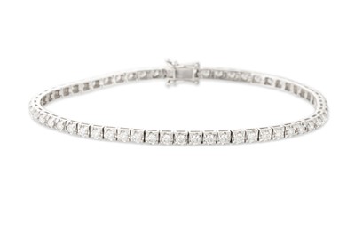 Lot 155 - A DIAMOND LINE BRACELET, the brilliant cut...