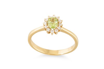 Lot 158 - A PERIDOT AND DIAMOND CLUSTER RING, mounted in...