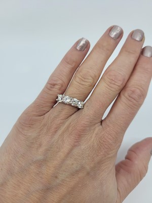 Lot 288 - A FOUR STONE DIAMOND RING, the brilliant cut...