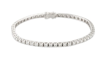 Lot 289 - A DIAMOND LINE BRACELET, the brilliant cut...