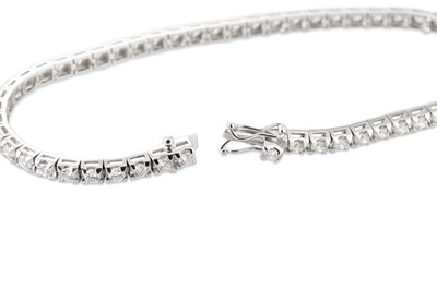 Lot 289 - A DIAMOND LINE BRACELET, the brilliant cut...