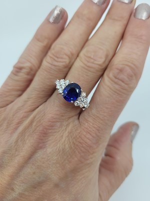 Lot 290 - A SAPPHIRE AND DIAMOND RING, the oval sapphire...