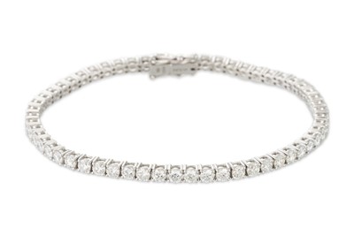 Lot 333 - A DIAMOND LINE BRACELET, the brilliant cut...